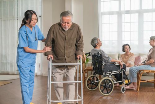 A VSH caretaker supporting an elderly patient at home